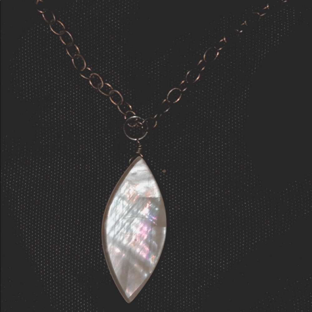 long necklace with leaf-shaped pendant